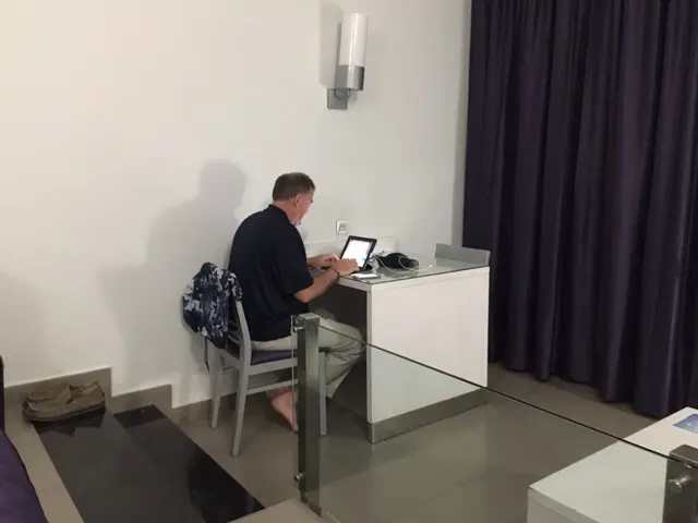 The blogger intensely at work in his hotel room....