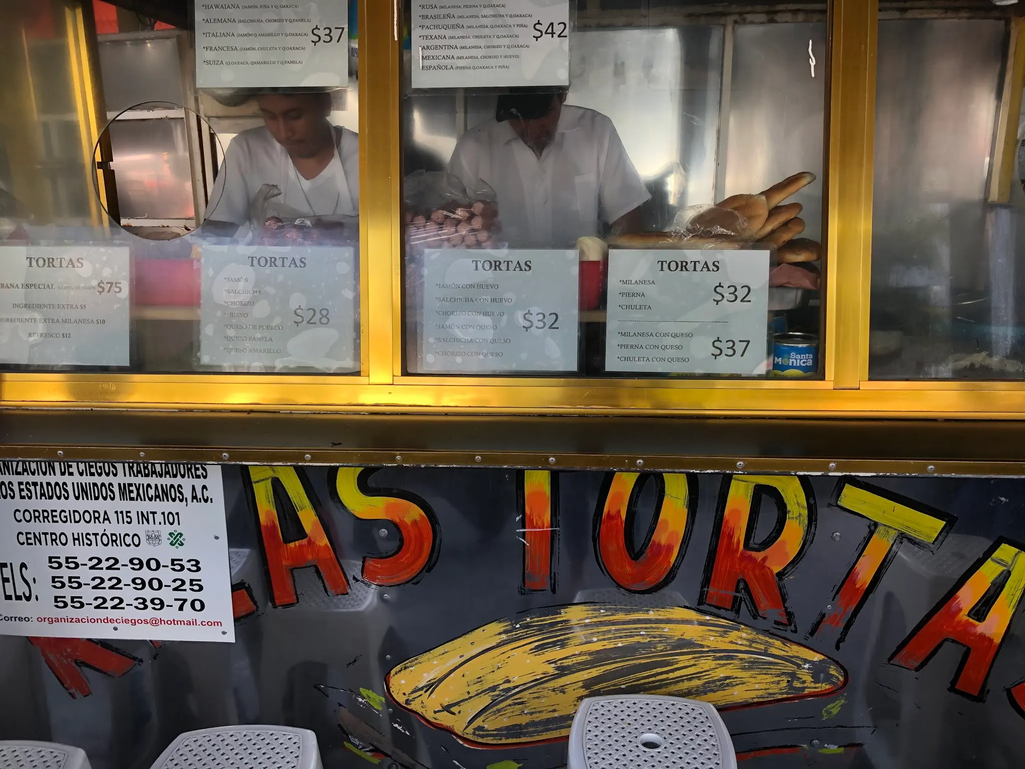 The torta stand with two cooks making the sandwiches...