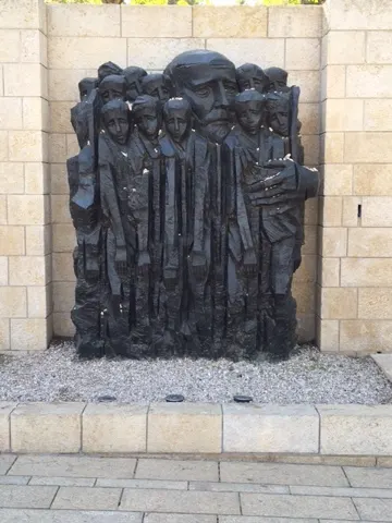 Apparently, there was a teacher who helped many of the Jewish children survive.escape. This shows him surrounded by some of his kids...