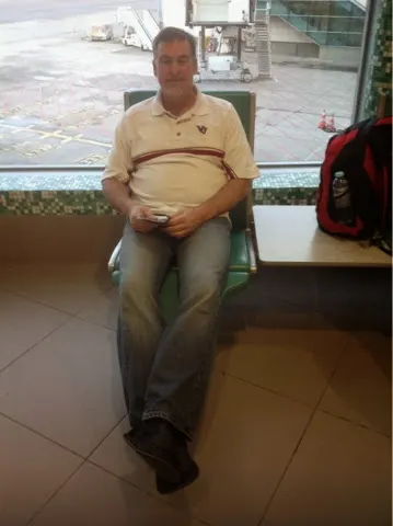 Sitting on a seat with a leg extender. First time I had seen this I ban airport.