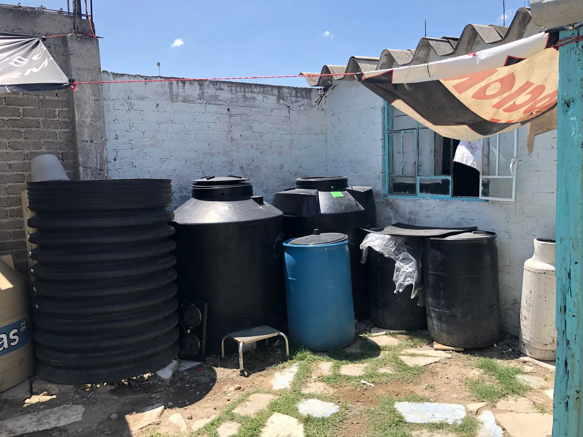 This where they collect and store water for bathing, washing clothes, flushing toilet, washing dishes and so on. When it rains, they funnel the water to buckets to capture the rain water. But trucks do come around to sale them water if they need it.