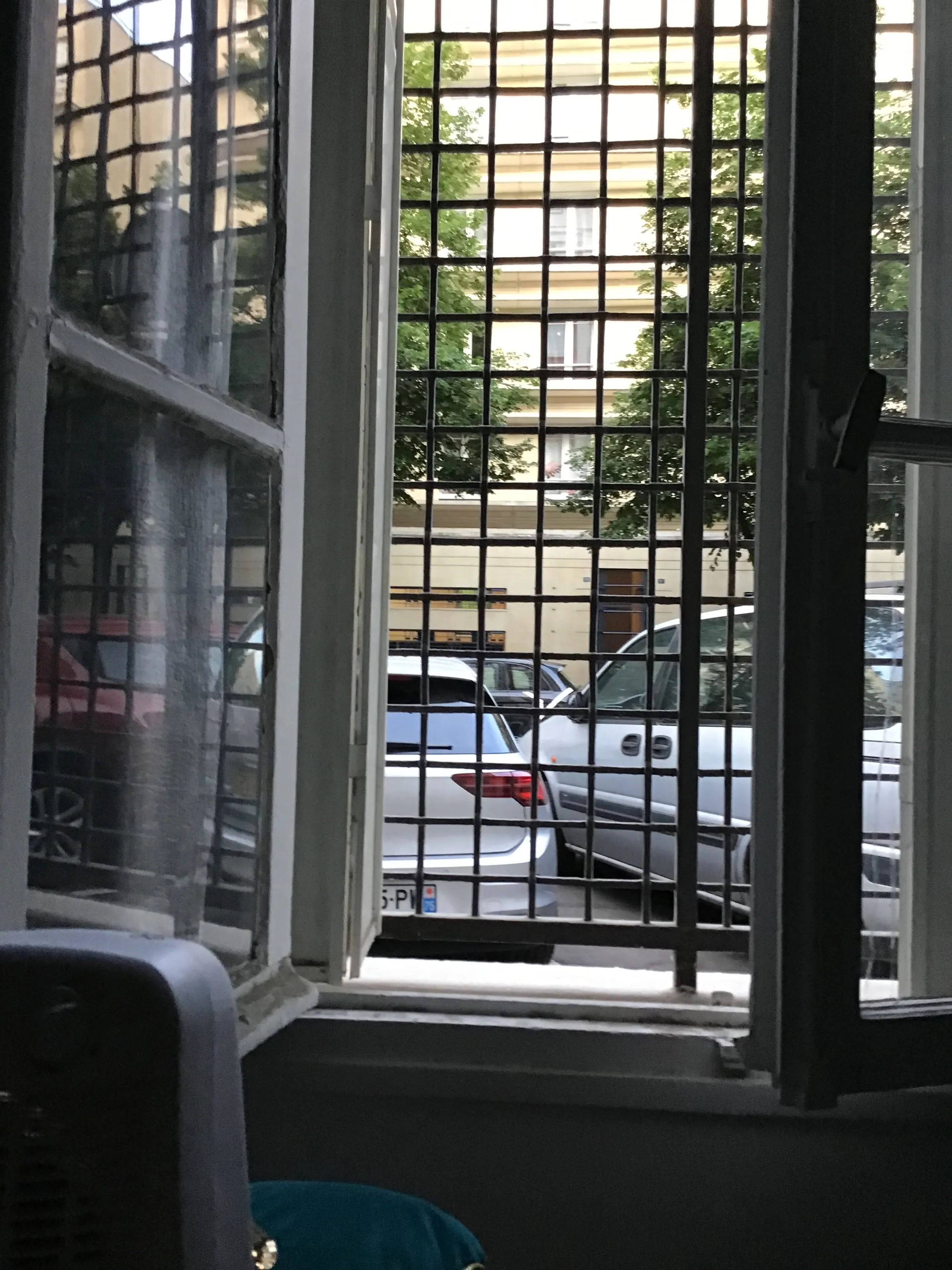 I took this picture sitting on the edge of my bed. People walk by fairly often between the window and the cars…and they kind of glance in. I hope it cools down quickly so I can close these windows as I know there will be street lights.
