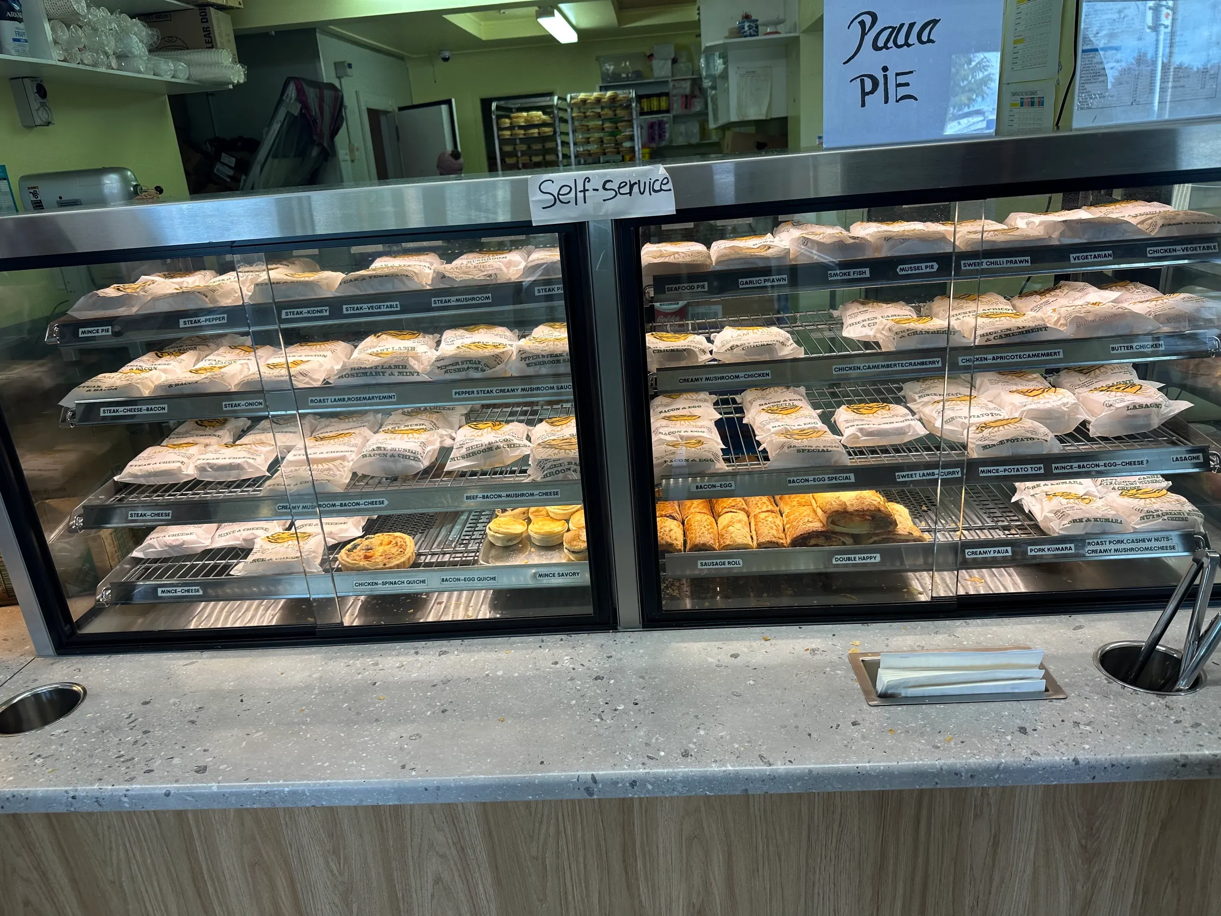 All those things in white wrappers are different types of meat pies. An amazing selection of different types.