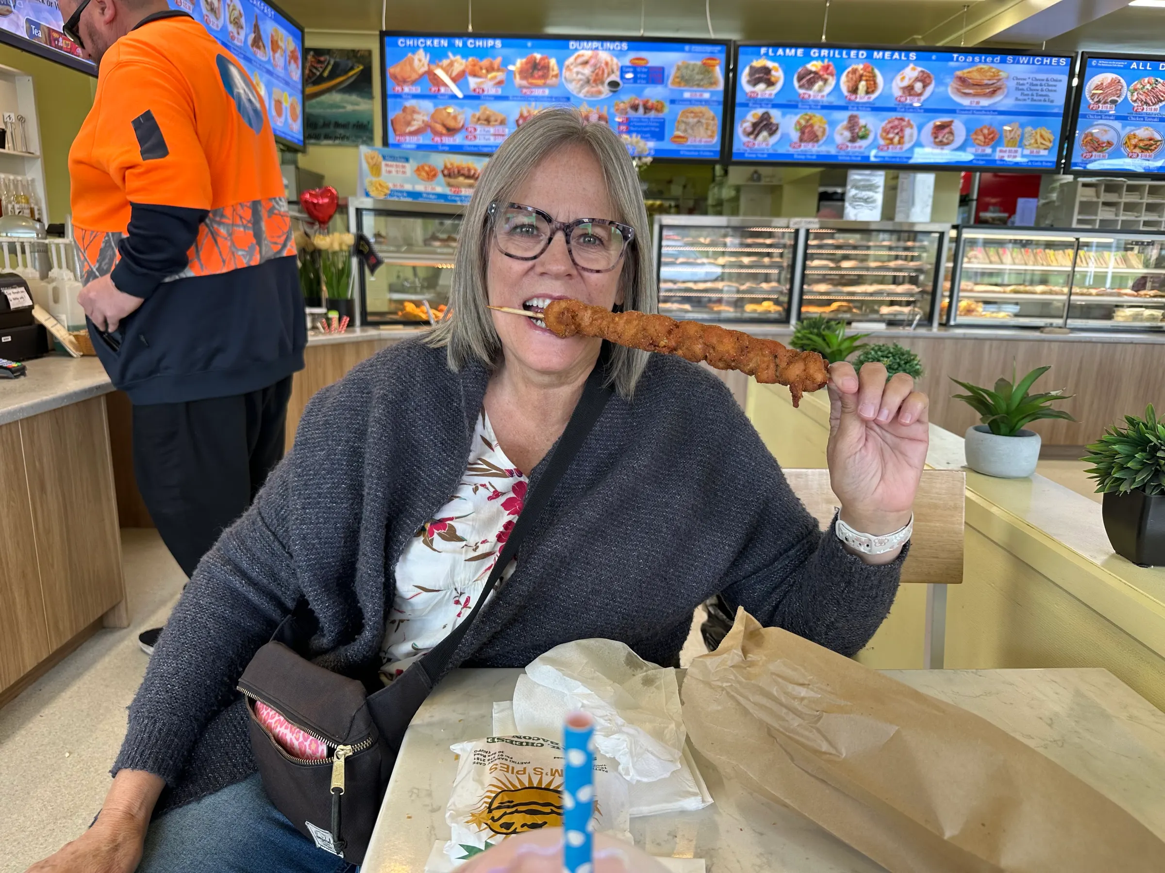 Denise taking her first bite of her satay. It was so yummy.