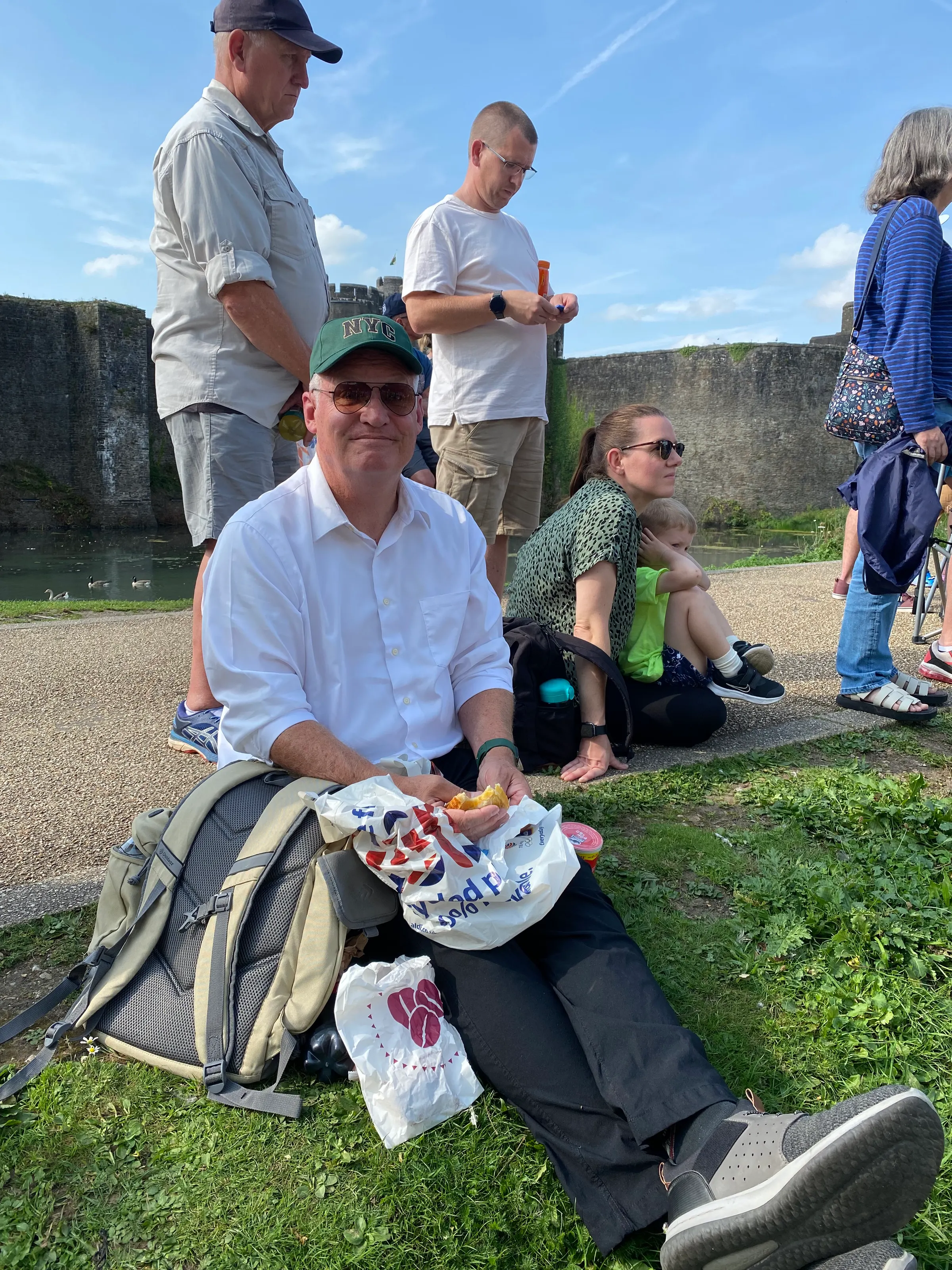 Pat laying staking his spot to watch the end of the Tour of Britain. You can see the castle in the background.