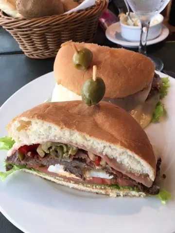 The Uruguayan 'hamburger'. I think it is called a 'Chivito'. You can get it with beef or chicken. It has all kinds of things on it...olives, lettuce, boiled eggs, tomatoe, and so on. It came with a nice helping of French fries too.