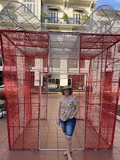 This is Denise standing under a Christmas present that lights up at night. They still have lots of Christmas stuff still up in all the plazas.