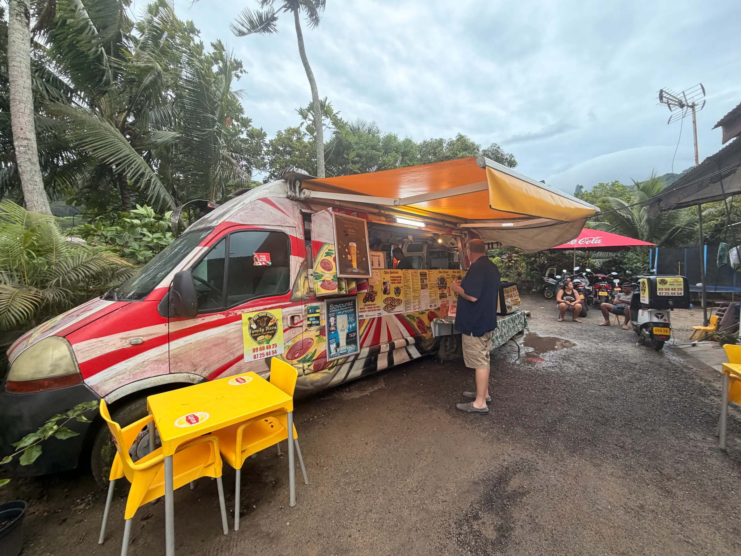 This is a picture of the food truck where we bought our pizza. A couple of folks are waiting to go deliver pizzas on their scooters. Lots of scooters over here.