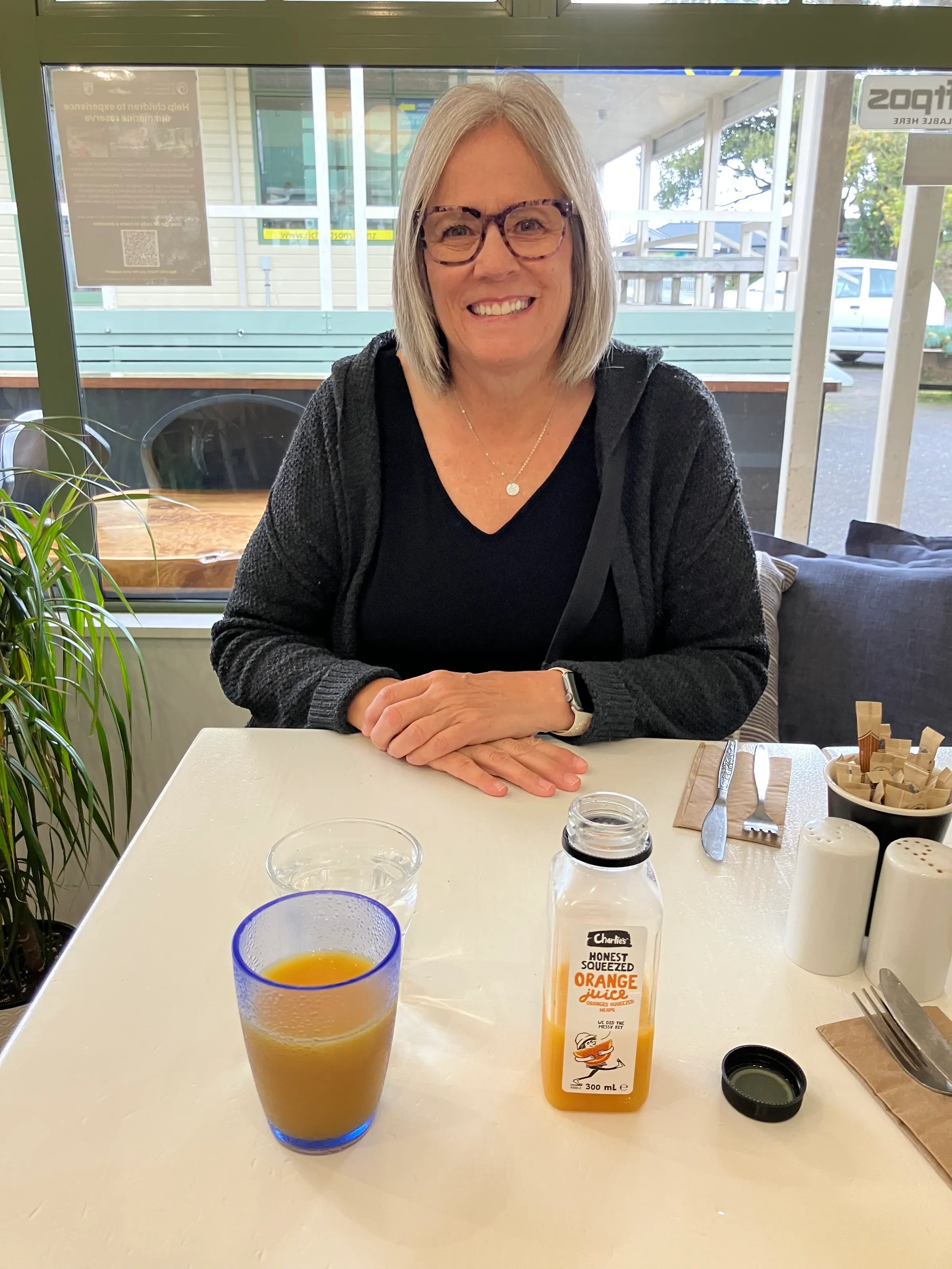 Denise waiting for her breakfast to be brought to her in Hahei.
