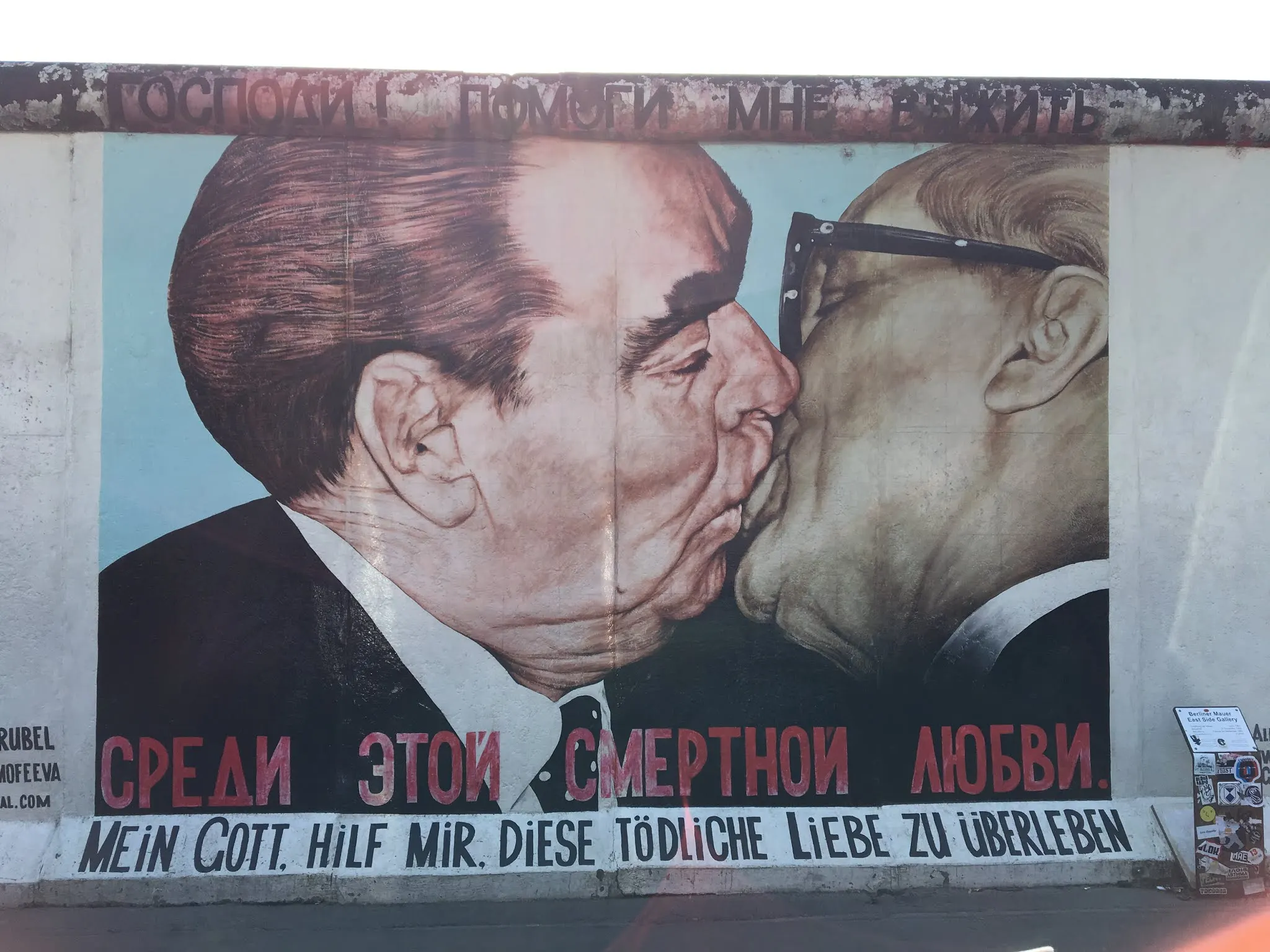 The famous mural of the Eastern Berlin and West Berlin leaders agreeing to something.