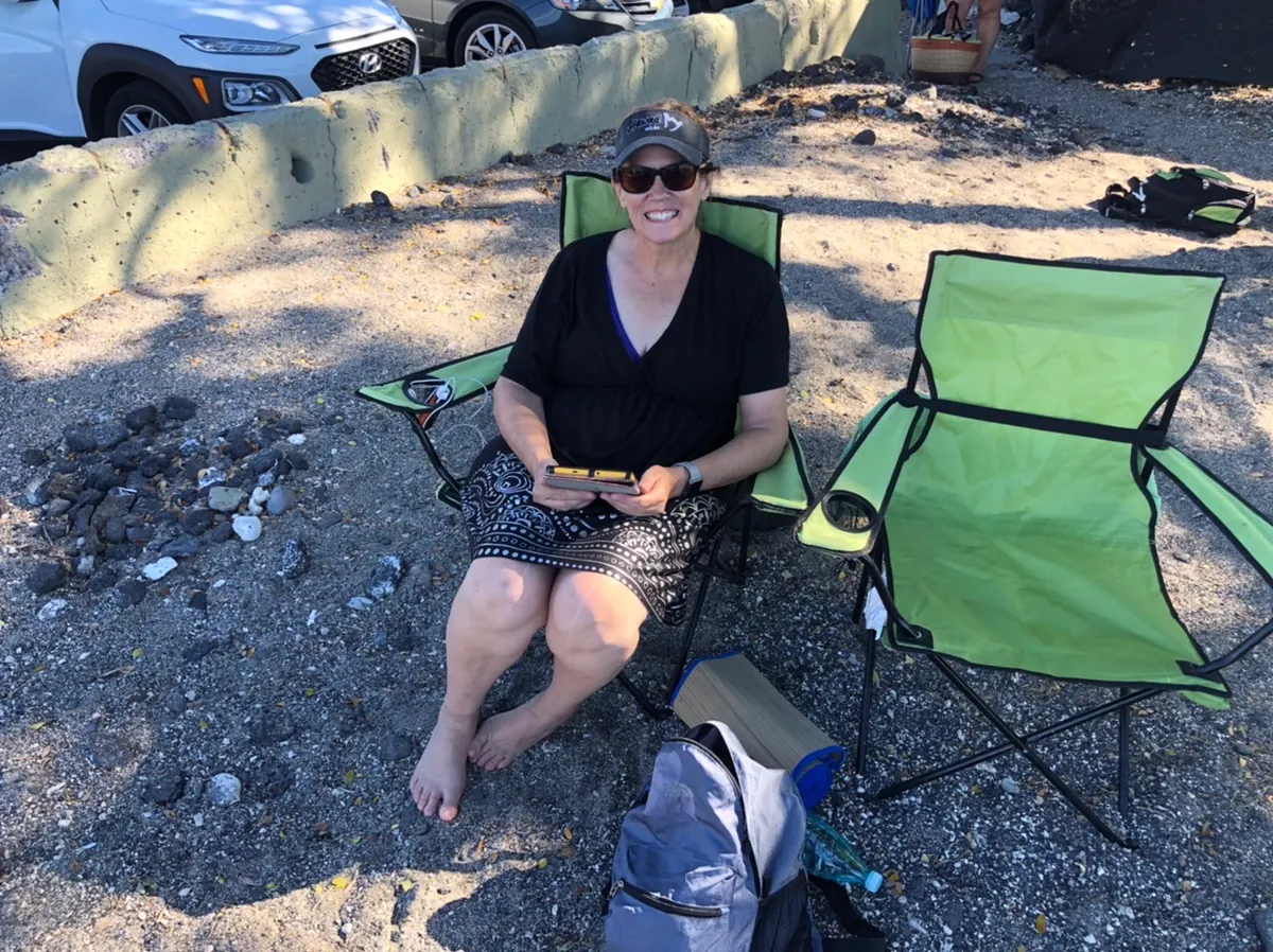 Enjoying her shade at the other beach...you spell it!