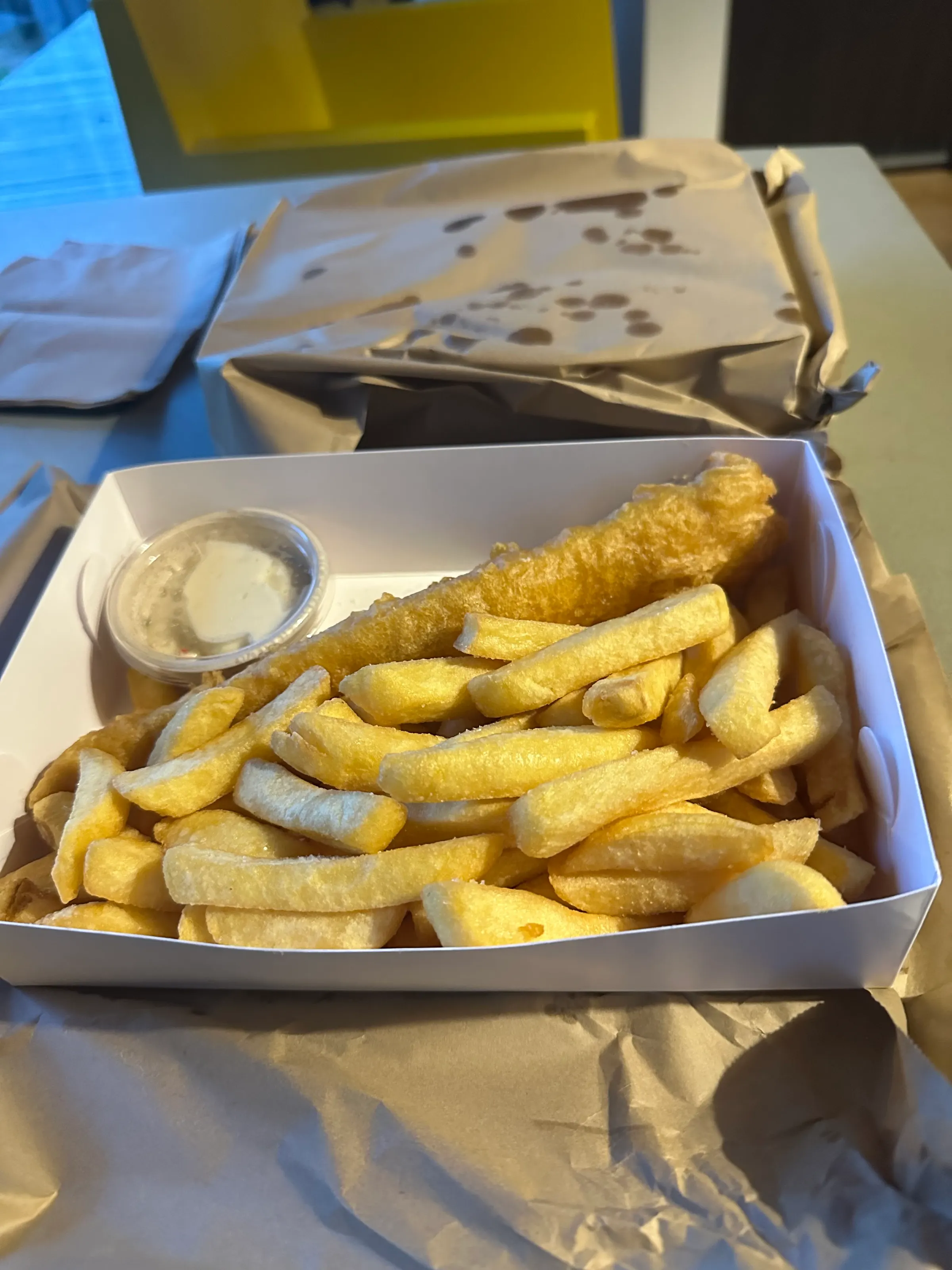 Our fish and chips dinner given to us in brown bags. It was quite good.