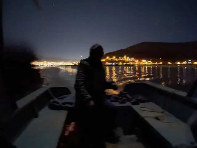 This was a really cool shot looking back at Puno lights and the outline of our host Joel navigating the boat.