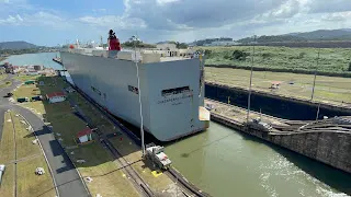 In this picture you can see how close the boat is to each side. You can also see the tractors at the front and at the rear that are pulling the boat through. They are almost done and the boat is almost launched into the Pacific Ocean bay here.