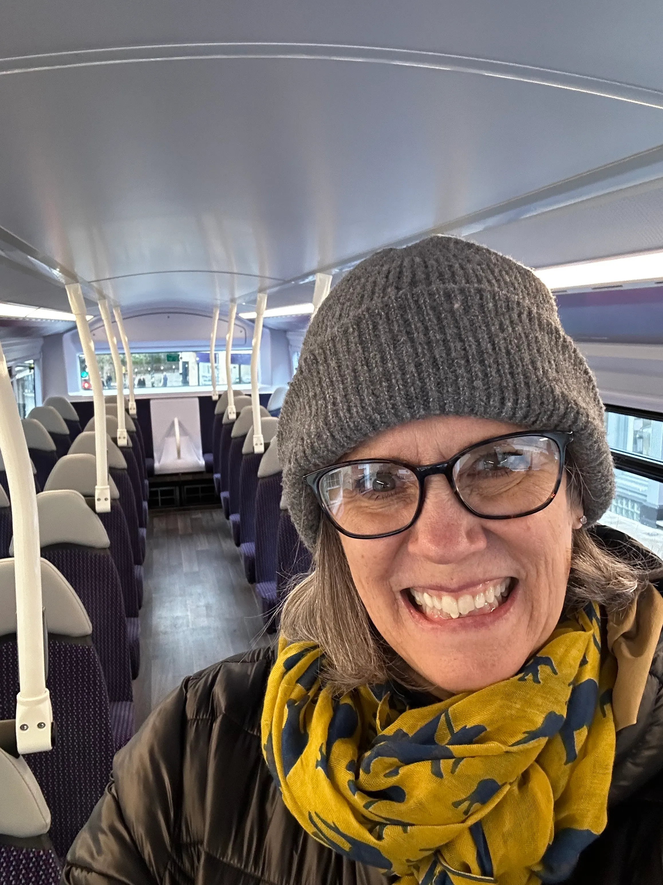 Denise riding the double decker bus on the 2nd floor by herself. Not sure why she did that. She came down half way through the journey.