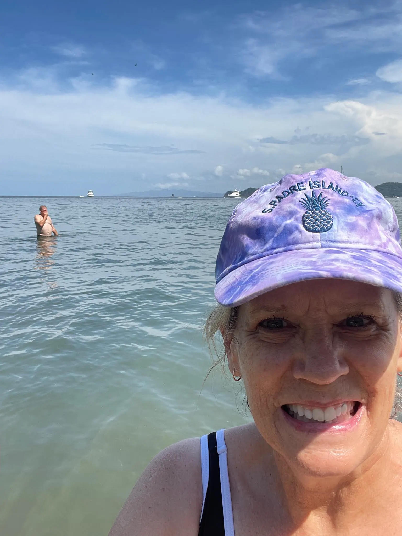 Fat guy in the water photo bombing the selfie!