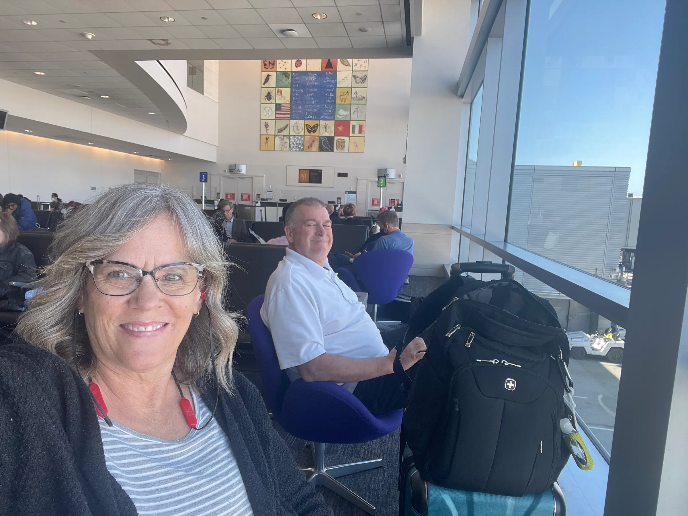 Us at our gate watching the ground crew work. They do lots, as it turns out.