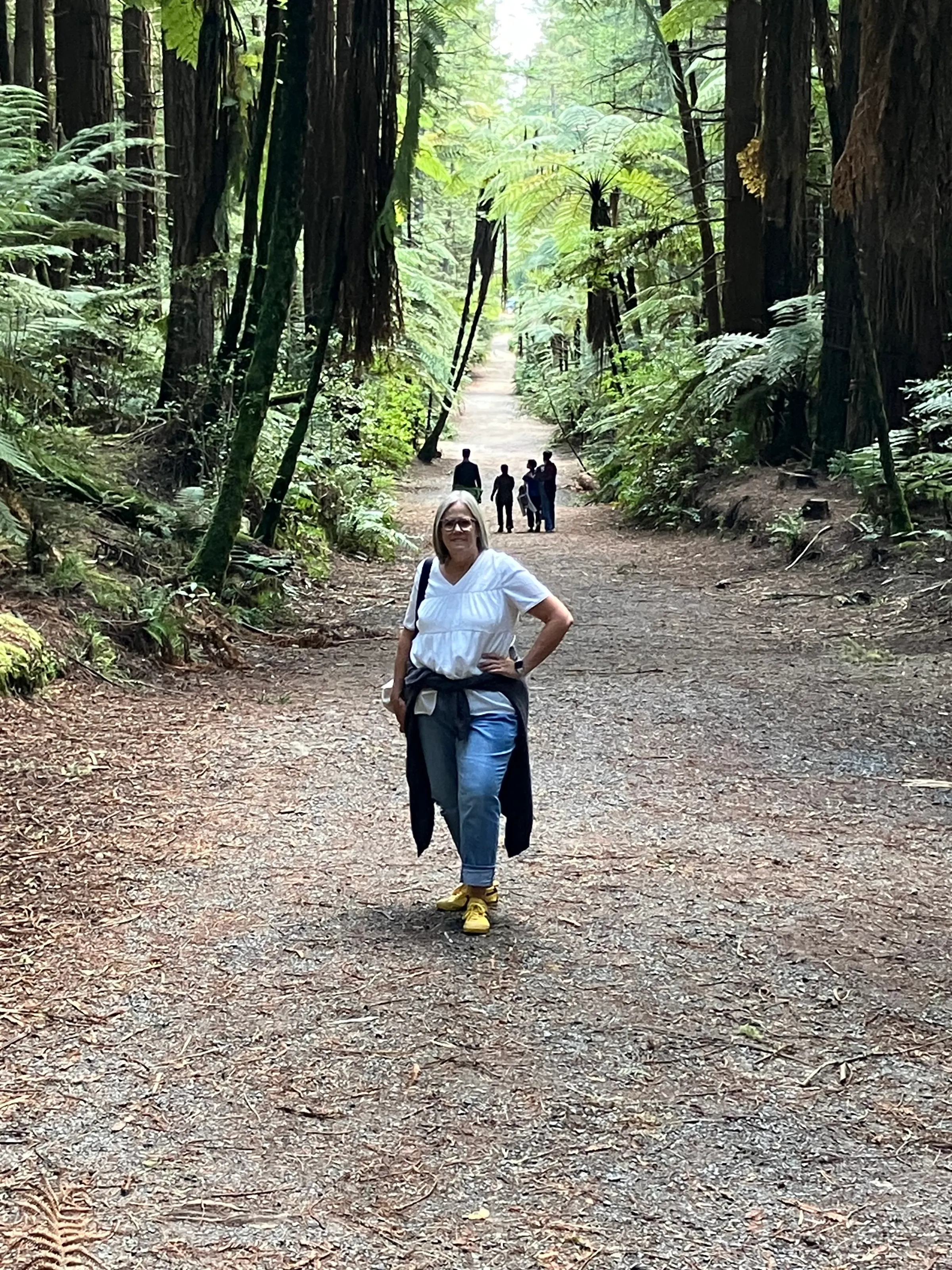 A happy hiker looking forward to elevating herself into a walk ‘in the trees’ high above the ground.