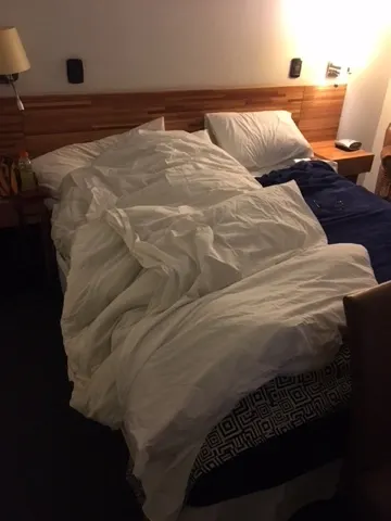 At 7 PM...yes...Denise is buried under this blanket trying to get warm from chills while I try to figure out a way to get cooler. I did go to the store to get some Gatorade and water. We bought some Amoxicilin from a pharmacy. Let's hope she resurrects for a big travel day tomorrow.