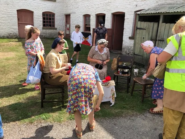 Some of the lady docents getting ready for some type of demonstration of a bomb going off.