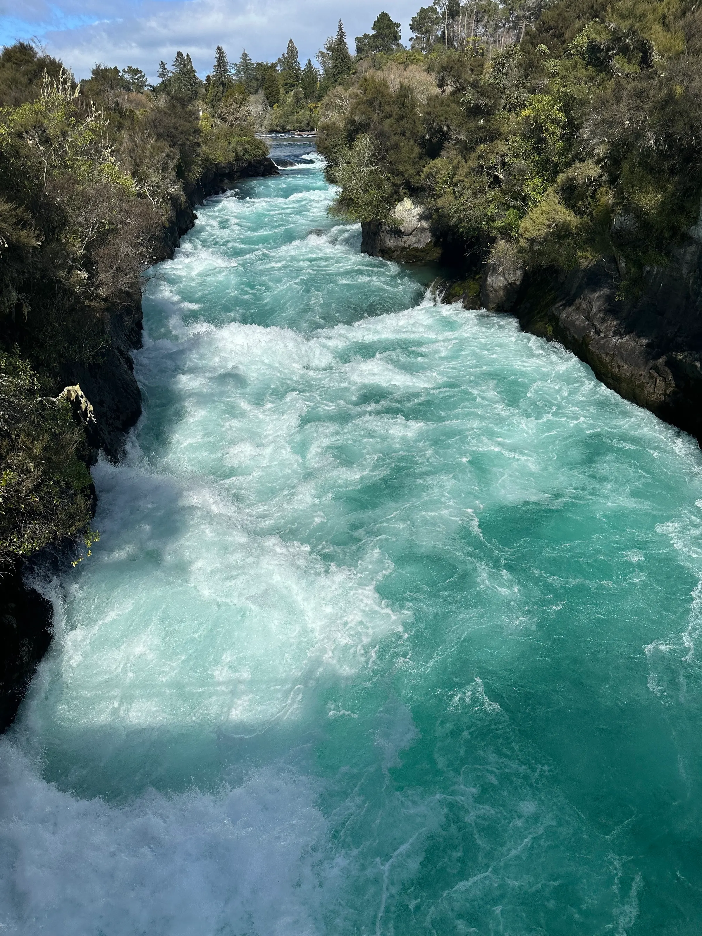 The water leading to Huka Falls flows through a narrow gorge. I guess a few boaters have tried to pass this and take the plunge over the falls. But the undertow is so great at the base of the falls, that it sucks the boats down and destroys them.