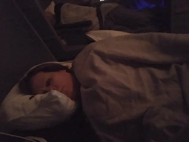 Denise enjoying this flight...no watching all night movies for her!