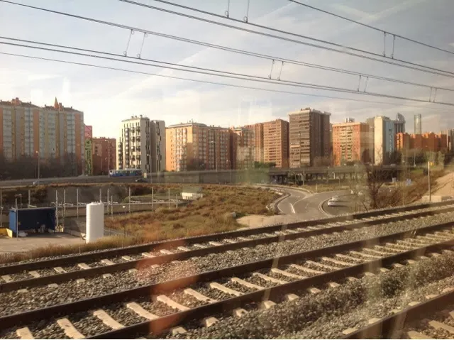 Apartment complexes in Madrid through train window.