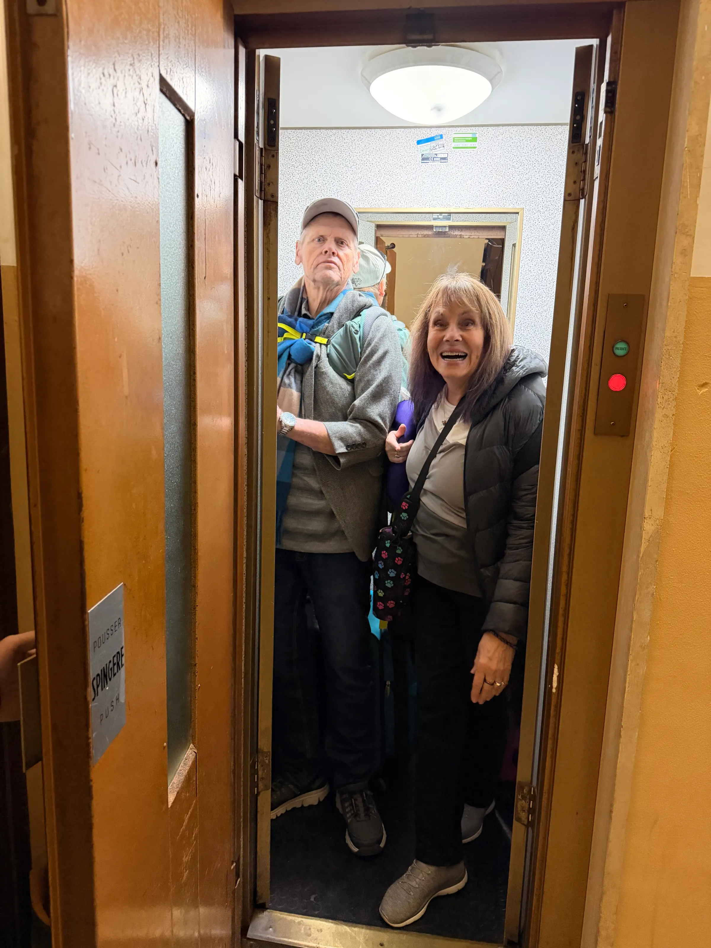 Cramming into the small elevator here in this building. I think it has 5 or 6 floors to it.