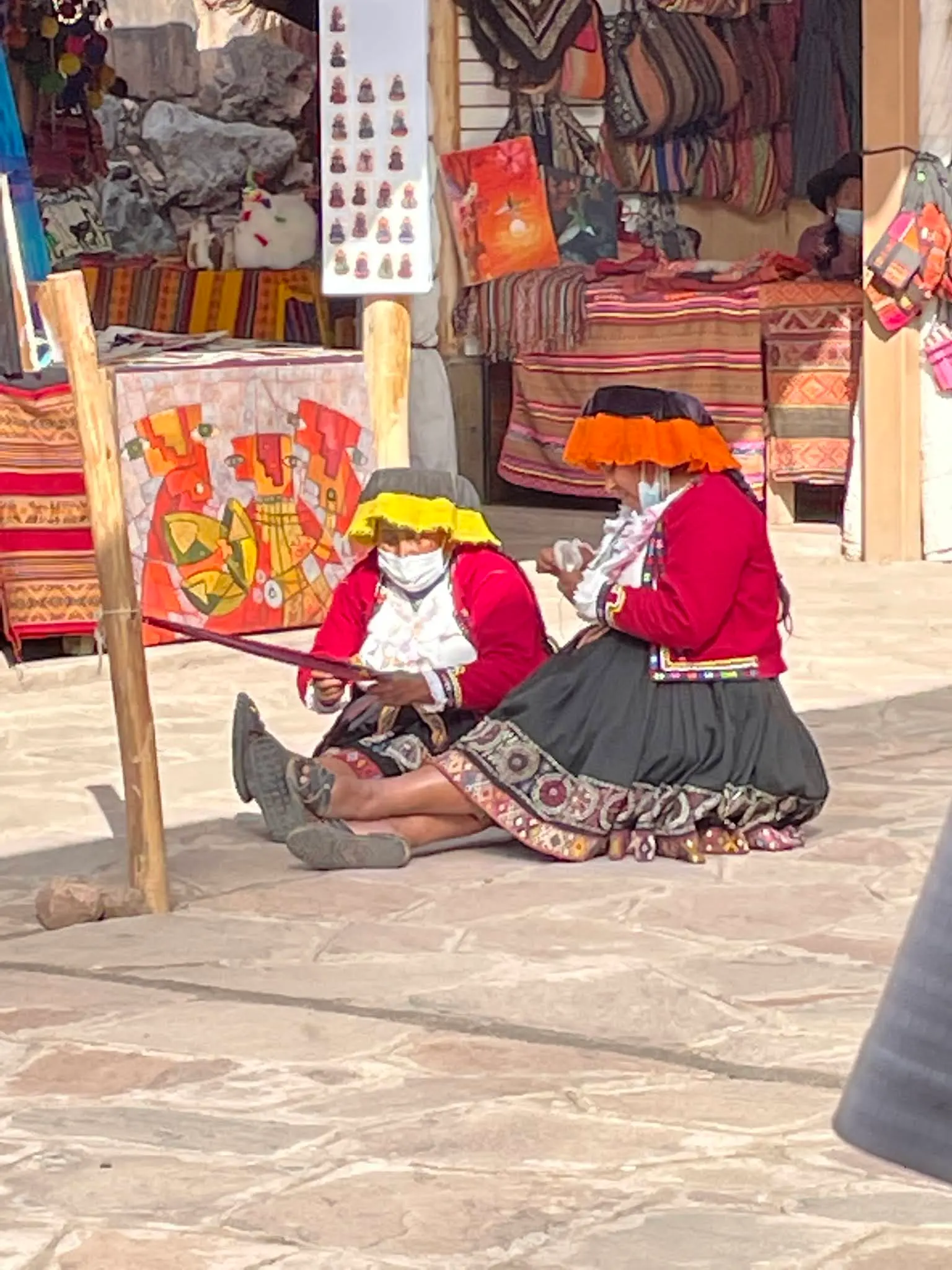 A couple of Peruvian women making something at the Artisian Market in Pisac.