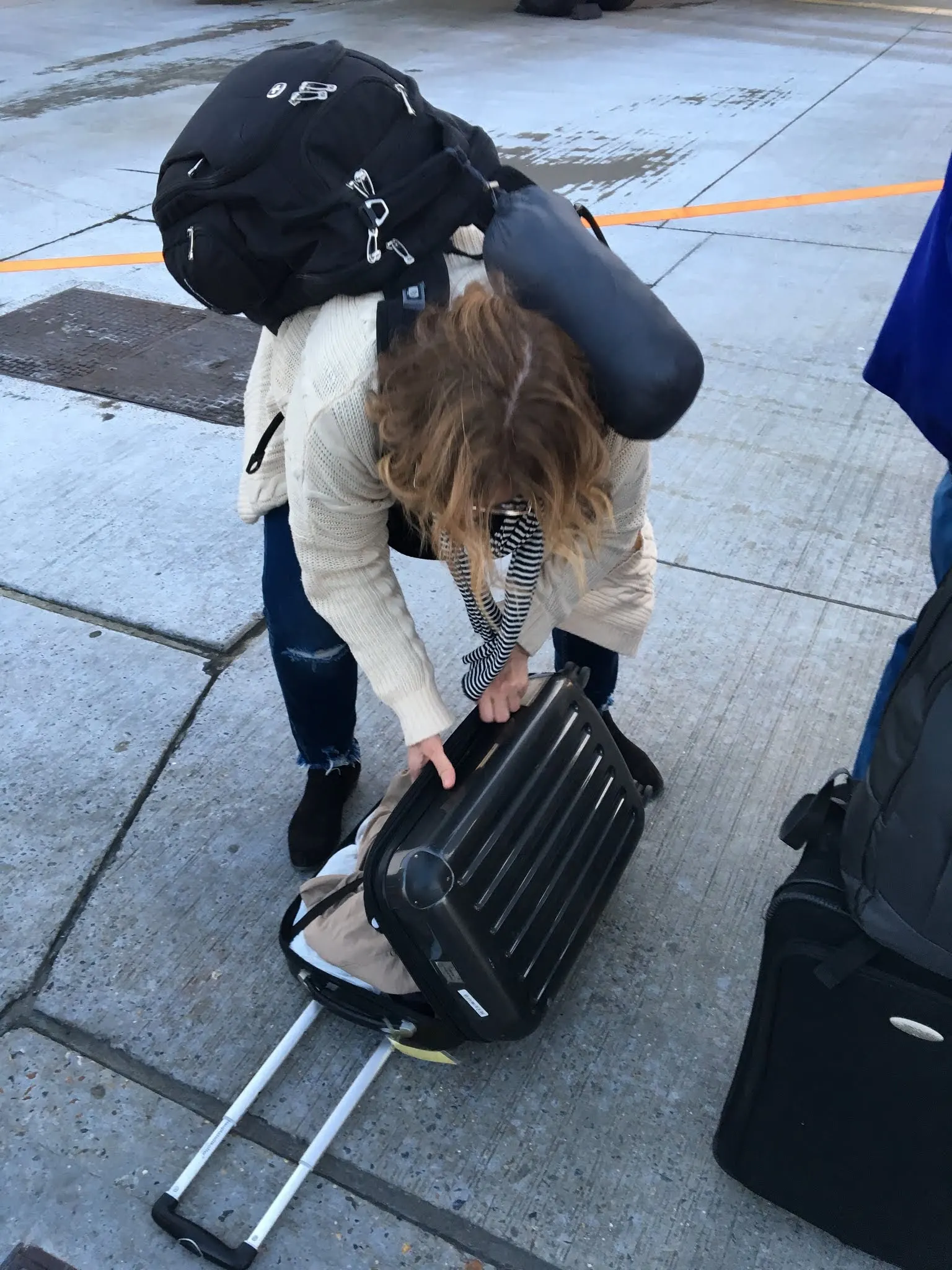 Denise repacking on the Tarmac before getting on the plane