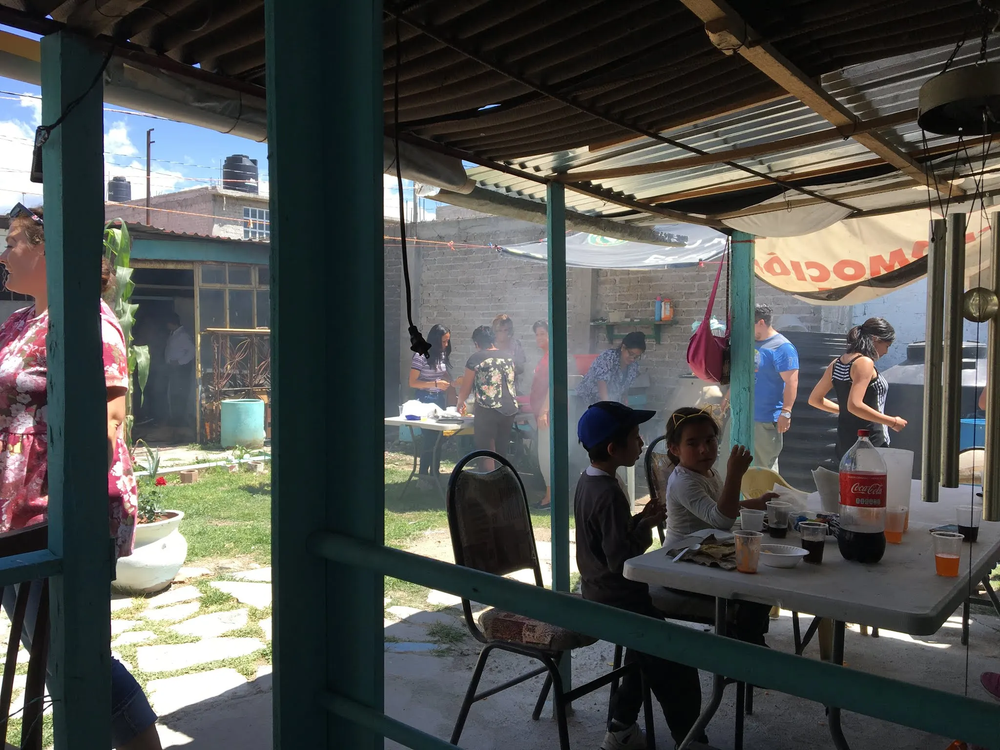 This picture shows the little courtyard. You can see the smoke from the open fires they were using to cook the food. The women to the rear were preparing Gordon’s and tortillas I think. All so tasty and good. Just a different way to cook it all. All the women jumped in and cooked...even Denise and Karlie!